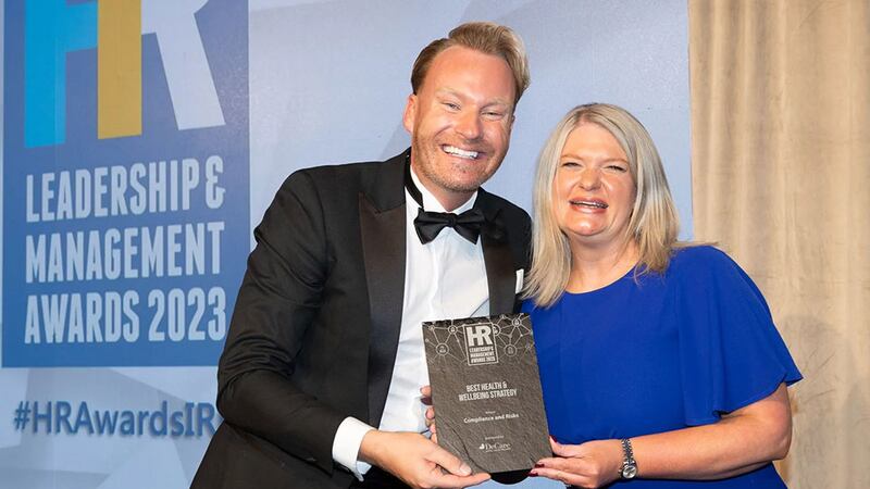 David Casey, wellness and health promotion manager, DeCare, presents the best health & wellbeing strategy award to Orla Murphy, Compliance and Risks
