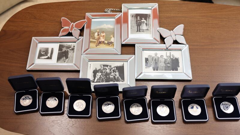 Family photographs  with the  medals Máirín Hughes has received each year since turning 100. Photograph: Dara Mac Dónaill