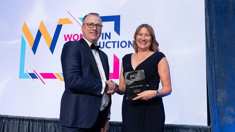 Tomás Kelly, awards judge, presents the excellence in bids & tenders award to Gayle Foulds, Cogent Associates