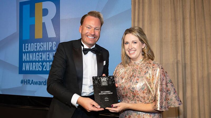 David Casey, wellness and health promotion manager, DeCare, presents the best learning & development strategy award to Amber Hanna, Avolon