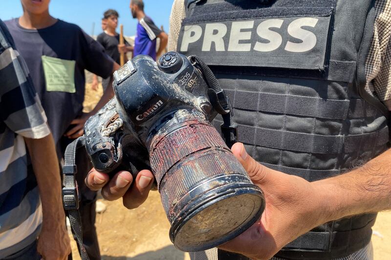 A journalist holds a camera belonging to Palestinian photojournalist Hussam al-Masri, a Reuters contractor who was killed in an Israeli strike on Nasser Hospital. Photograph: AFP via Getty Images