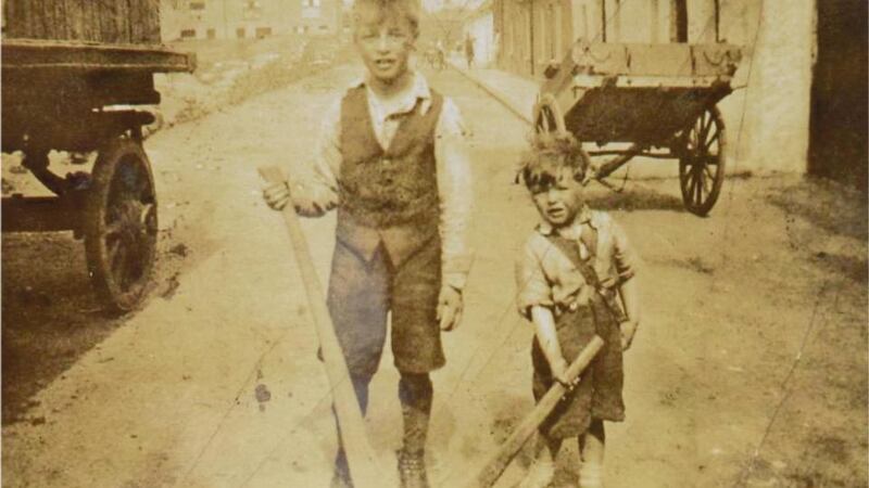 Joe Rock (on left) and his younger brother Christy with their hurleys on Love Lane, Ballybough, in Dublin in 1936