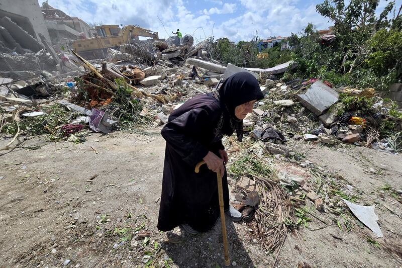 A woman walks through the southern Lebanese village of Deir Qanun al-Nahr a day after Israeli strikes. Photograph: Kawnat Haju/AFP via Getty Images