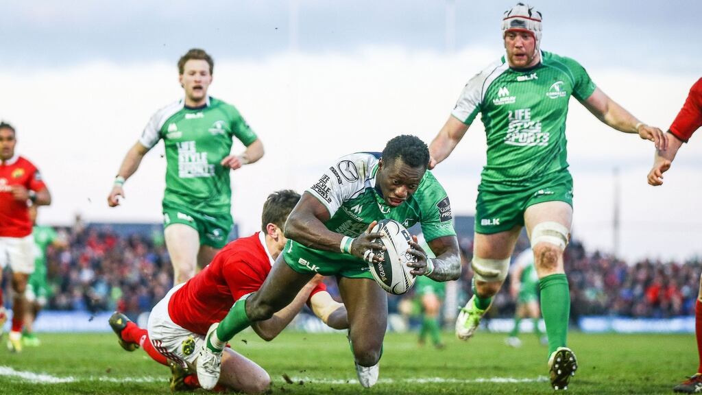 Niyi Adeolokun scores Connacht’s third try despite the tackle of Munster’s Darren Sweetnam during the Guinness Pro 12 game at The Sportsground in Galway. Photograph: James Crombie/Inpho