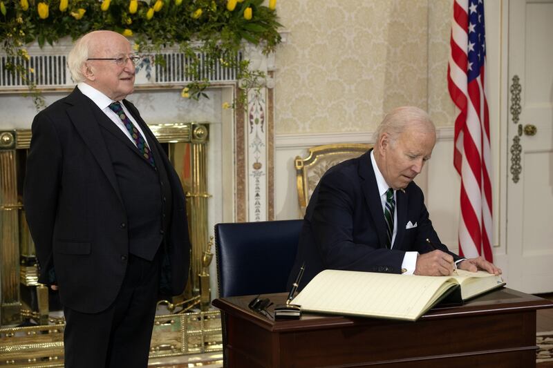President Joe Biden signs the guestbook while talking with President Michael Higgins at Áras an Uachtaráin. Photographer: Tony Gavin/Bloomberg