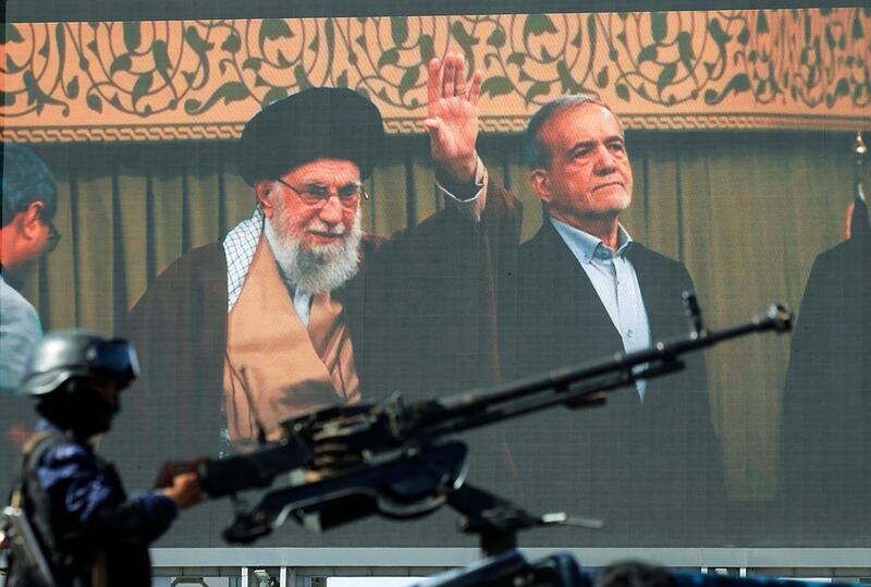 A Houthi soldier mans a machine gun beside a digital billboard featuring the late Iranian supreme leader Ayatollah Ali Khamenei and Iranian president Masoud Pezeshkian during a solidarity rally with Iran in Sana'a, Yemen, on April 10th. Photograph: Yahya Arhab/EPA