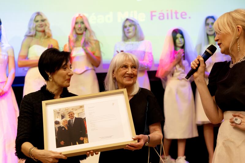 Deirdre Fraser, wife of Ireland's Ambassador to Britain, Martin Fraser, makes a presentation to Margaret Curran, with Siobhan Reynolds as MC, at the elders fashion show at the Irish Cultural Centre in Hammersmith. Photograph: Mark Paul