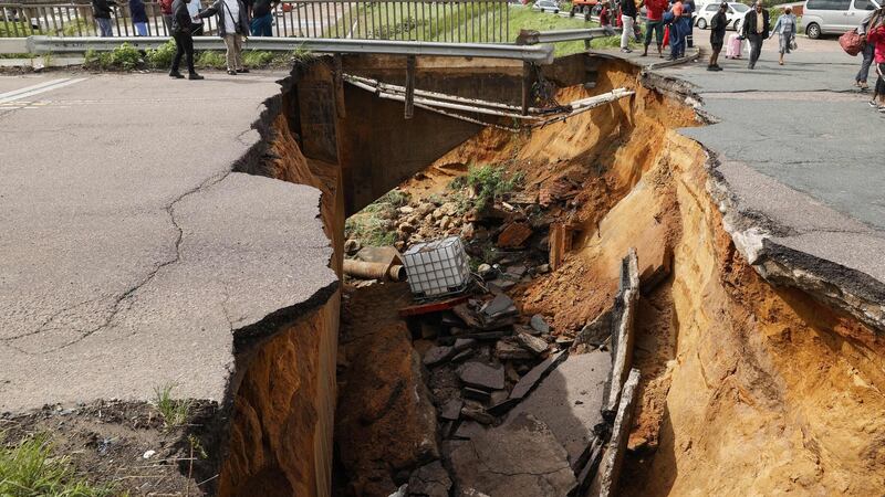 A crack in the road following heavy rains and winds in Durban. Photograph:  Phill Magakoe/AFP via Getty Images