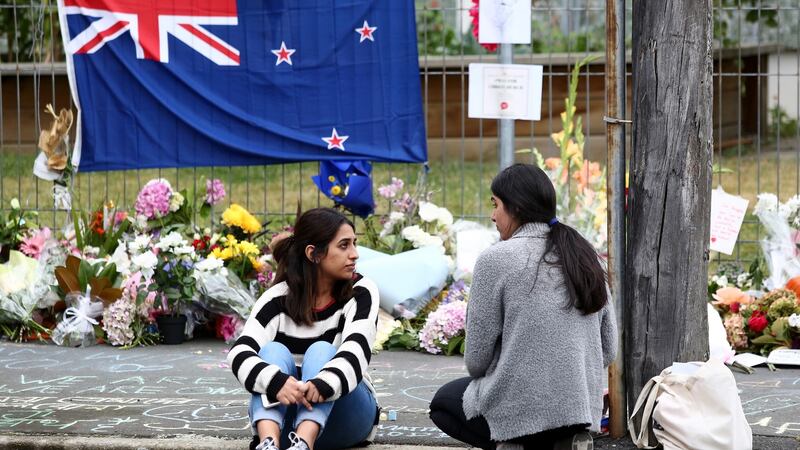 Locals lay flowers and condolences in tribute to those killed and injured in Friday’s terrorist attack in Christchurch. Photograph: Dianne Manson/Getty