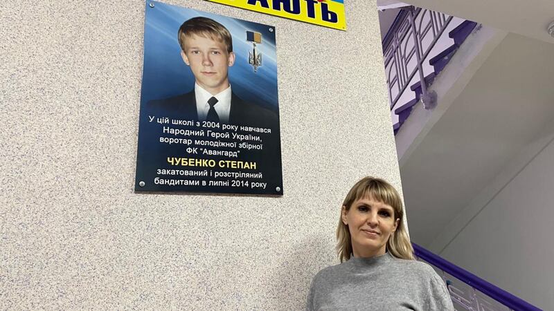 School head Olena Mironenko in Kramatorsk stands by a photo of former pupil Stepan Chubenko (16) who was shot dead in 2014 by pro-Russian separatists. Photograph: Daniel McLaughlin