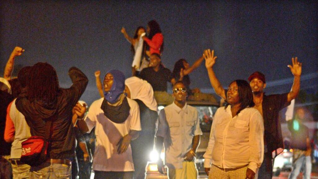 Demonstrators gather last night to protest at the shooting dead of Michael Brown in Ferguson, Missouri. Photograph: EPA