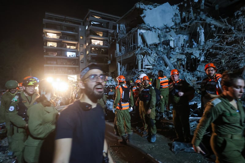 Israeli first responders arrive at a site hit by a missile fired from Iran, in Ramat Gan on the outskirts of Tel Aviv, on Friday night. Photograph: Gil Cohen-Magen/AFP via Getty Images