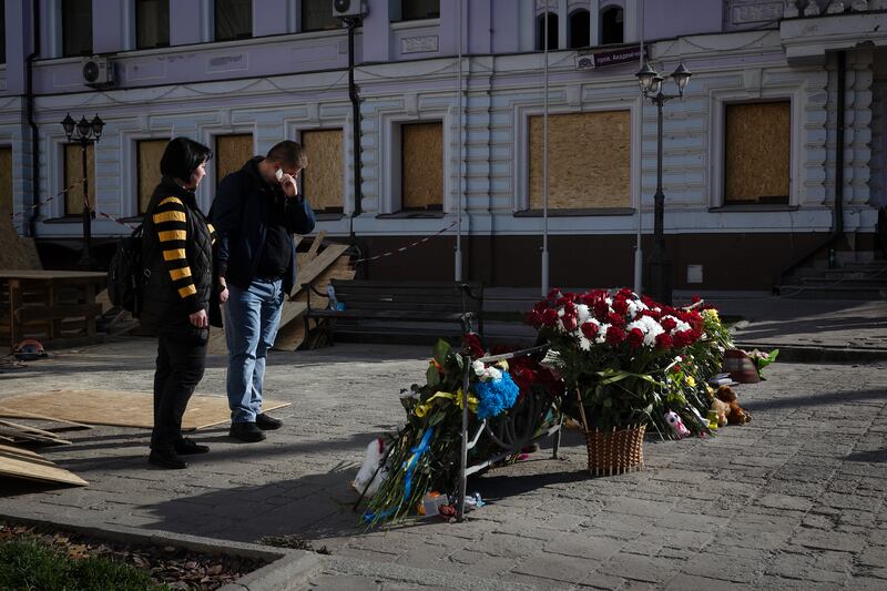 Mourners lay flowers at an impromptu memorial on Monday at the site of the Palm Sunday attack on Sumy, Ukraine. Photograph: Tyler Hicks/The New York Times