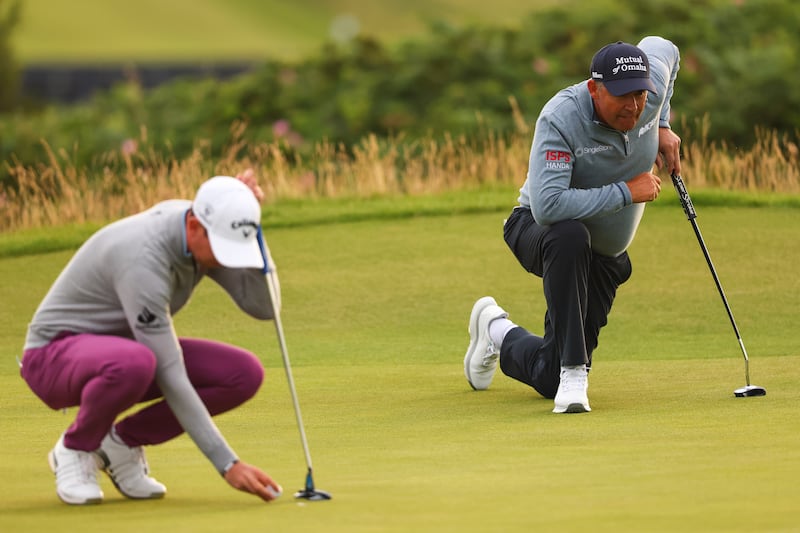 Padraig Harrington and Tom McKibbin line up their putts. Photograph: Ben Brady/Inpho