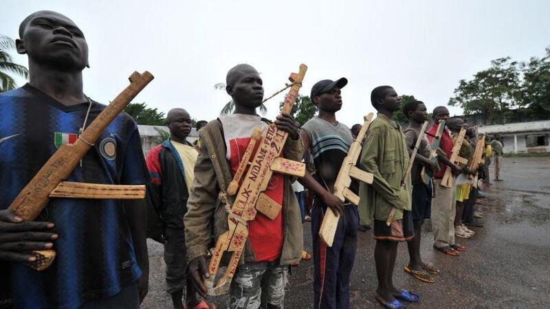 Members of the ex-Seleka rebels pose with wooden weapons in front of late Centrafrican emperor Jean-Bedel Bokassa’s palace in Beringo last month. Photograph: Getty Images