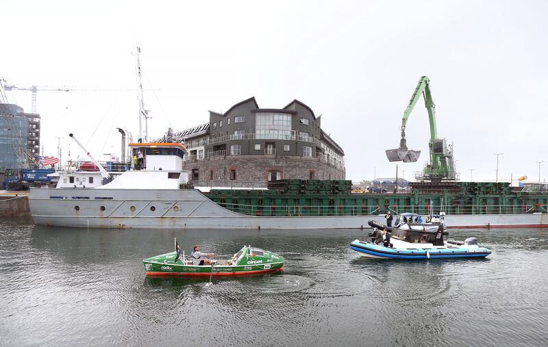 Damian Browne rows his boat from out on the bay into Galway Docks, after it was taken off the rocks at Furbo. Photograph: Joe O’Shaughnessy