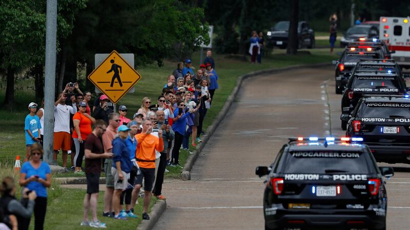 Onlookers wave as the motorcade carrying former first lady Barbara Bush’s body is seen along Memorial Drive in Houston, Texas, the US. Photograph: Aaron  M Sprecher/EPA