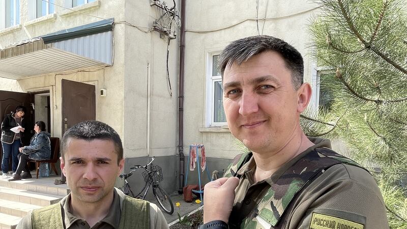 Oleksandr Berehovyi (left), the mayor of Bashtanka in southern Ukraine, and Vitaliy Homerskyi, a deputy on Mykolaiv regional council, who fought in defence of Bashtanka against Russian troops on March 1st. The patch on Homerskyi’s arm carries a phrase that has become a Ukrainian battle cry: “Russian warship, F**k off”. Photograph: Daniel McLaughlin