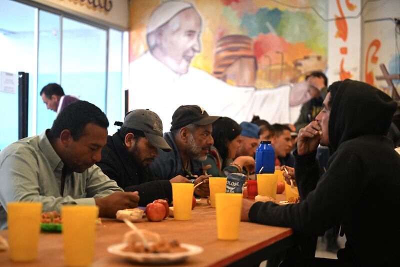 People eat next to a mural depicting Pope Francis at a Hogares de Cristo center in the Padre Carlos Mujica shantytown (known as Villa 31) in Buenos Aires on Monday. 

The Hogares de Cristo centres are a network of community centres created to help people struggling with drug addiction in the slums of Buenos Aires and were supported by Jorge Bergoglio, Pope Francis, when he was Archbishop of Buenos Aires. 

Photograph: Luis Robayo/AFP via Getty Images        