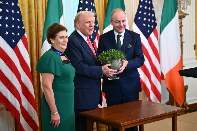 Taoiseach Micheál Martin and his wife, Mary O'Shea, present the bowl of shamrock to US president Donald Trump. Photograph: Mandel Ngan/AFP via Getty Images         