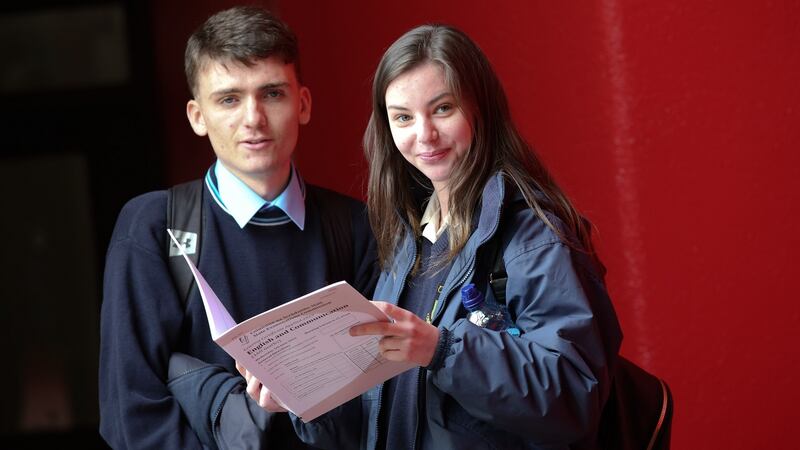 Applied Leaving Certificate students, Louis Murphy and Skyi Tobin  with the English and Communication paper after they sat the exam at St Tiernan’s Community College in Dundrum, Dublin. Photograph: Laura Hutton/The Irish Times