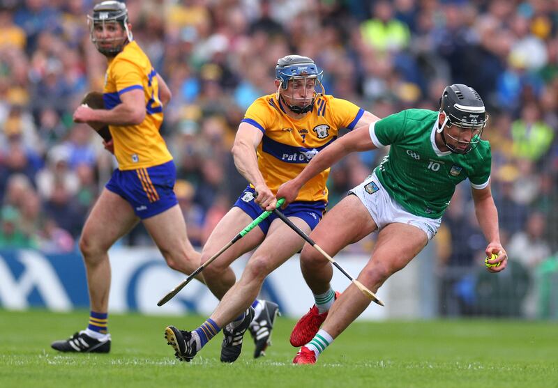 Clare’s David McInerney and Gearoid Hegarty of Limerick in action during the Munster hurling final. Photograph: James Crombie/Inpho
