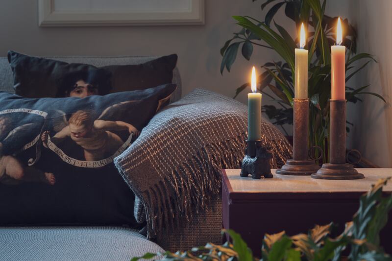 Cashmere merino throw, €129.95, antique brass effect candlesticks, €14.95, Scottie dog candlestick, €9.95, Goya cushion, €39.95, Vermeer cushion, €39.95 and Cherub cushion, €39.95, all from Russborough shop — russborough.ie Photograph: Joanna Barry