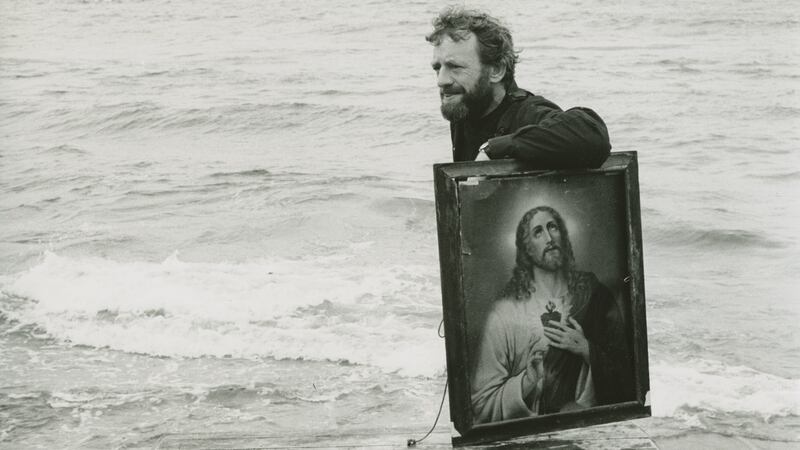 Druid co-founder Mick Lally bringing props for Druid’s Playboy from a boat to the Aran Islands, 1982. Photograph: James Hardiman Library.