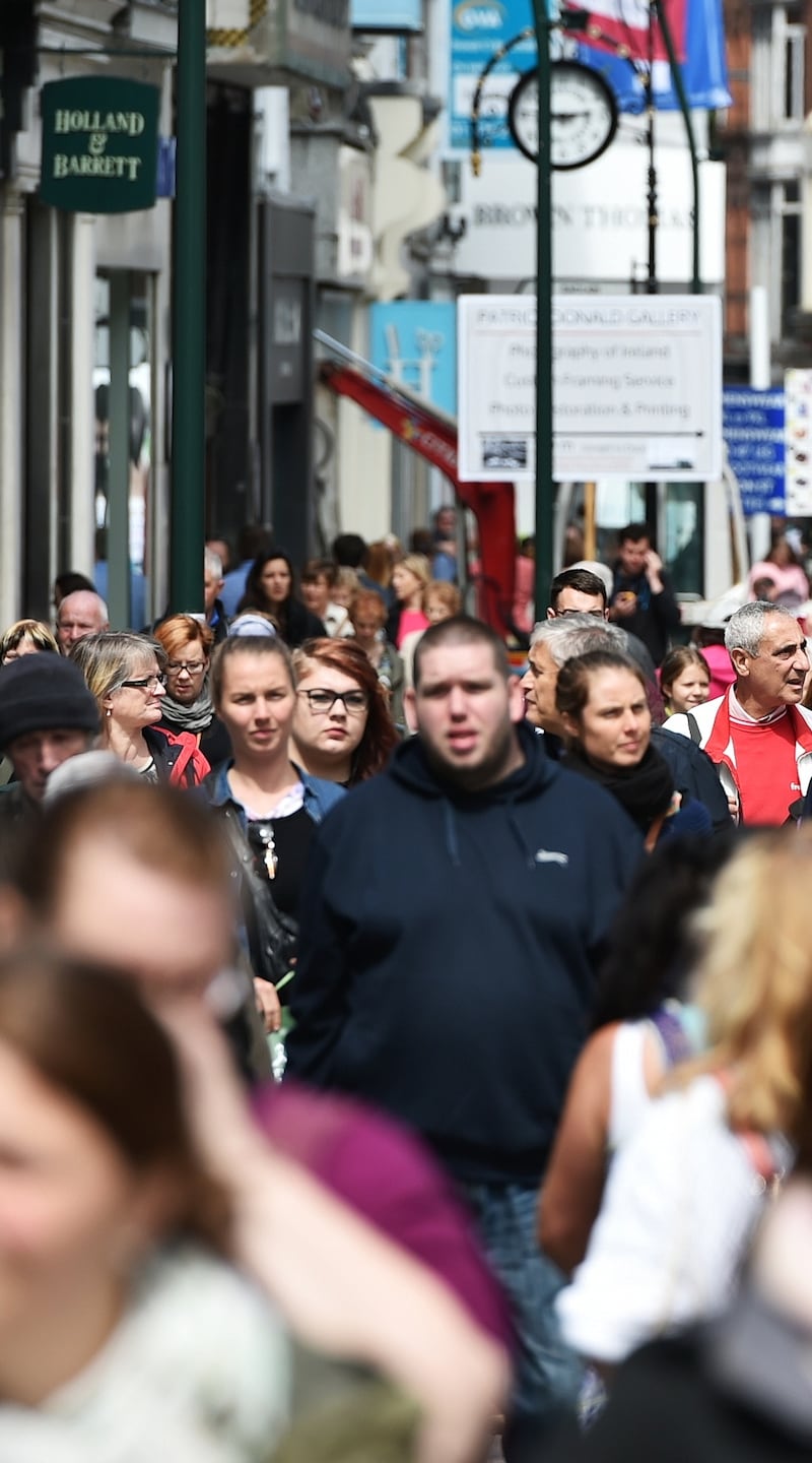Crowds of people walk on Grafton Street. The street is a main tourist attraction in the Irish capital, renowned for its lively atmosphere and shops.