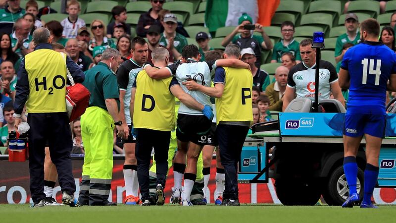 Joey Carbery of Ireland leaves the field injured.  Photograph: Donall Farmer/PA Wire.