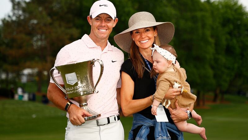 Rory McIlroy celebrates with the trophy alongside  wife Erica and daughter Poppy at Quail Hollow. Photograph:  Jared C Tilton/Getty Images