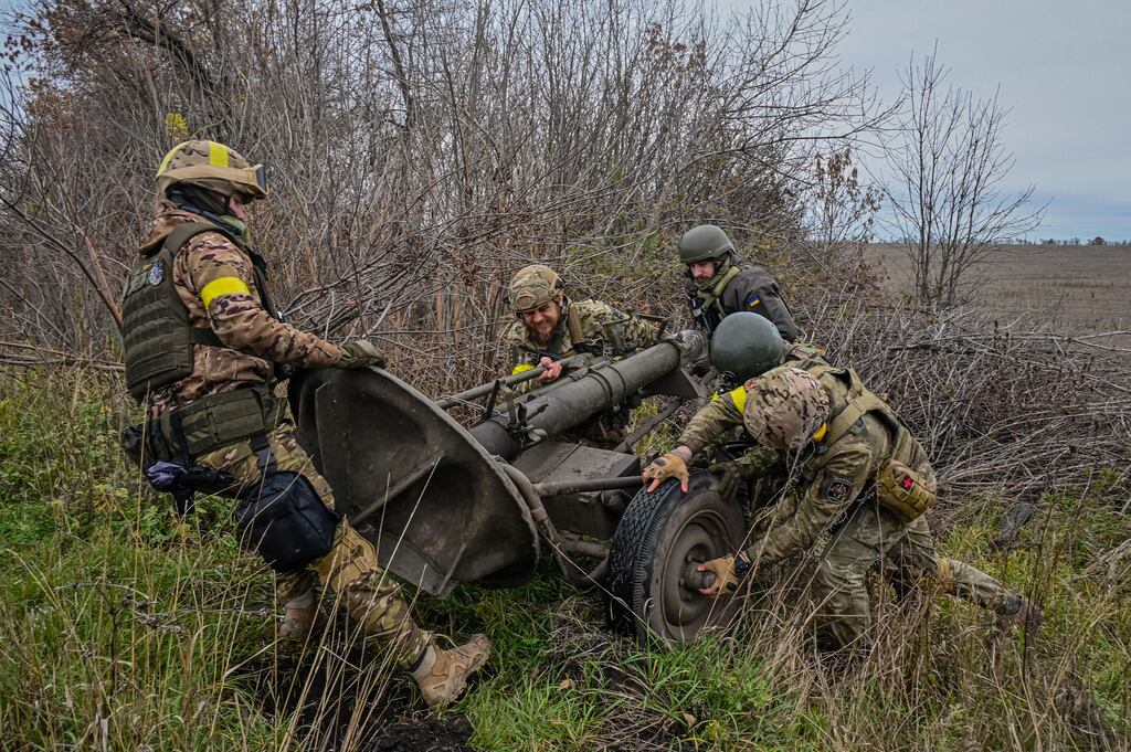 Members of the Ukrainian National Guard push a mortar launcher on the front line in the Kharkiv region on October 25th, 2022. Photograph: Sergey Bobok/AFP via Getty Images