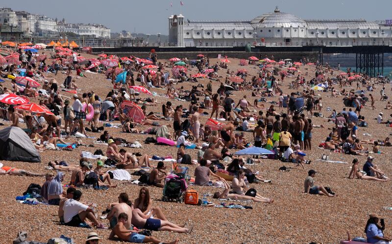People crowd the beach to enjoy the sunshine in Brighton, England, on Thursday. Photo: Carlos Jasso/AFP via Getty Images
