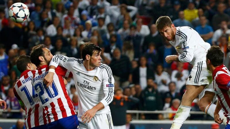 Real Madrid’s Sergio Ramos rises above the Atletico Madrid defence to score  his side’s equaliser  during their Champions League final  at Estadio da  Luz Stadium in Lisbon. Photograph: Michael Dalder/Reuters