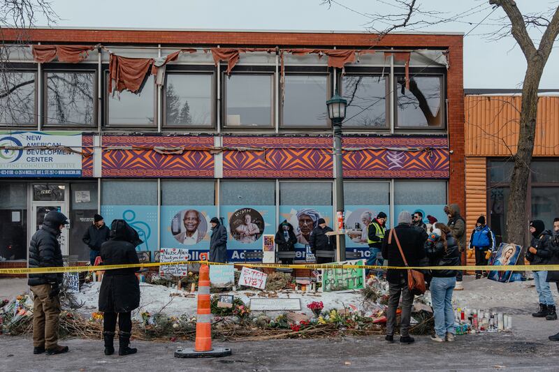 People gather around a makeshift memorial at the site in Minneapolis where Alex Pretti was shot and killed by federal immigration agents. Photograph: Jamie Kelter Davis/The New York Times
                      