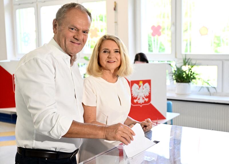 Prime minister Donald Tusk and his wife, Malgorzata, cast heir ballots at a polling station in Sopot, Poland. Photograph: Mateusz Slodkowski/AFP/Getty