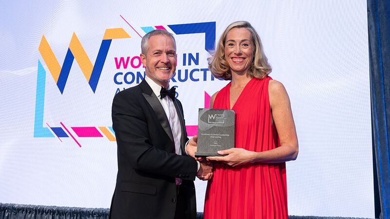 Gareth Lloyd, operations director at Walls Construction, presents the excellence in senior leadership - engineering award to Suzanne Tracy, SIRO