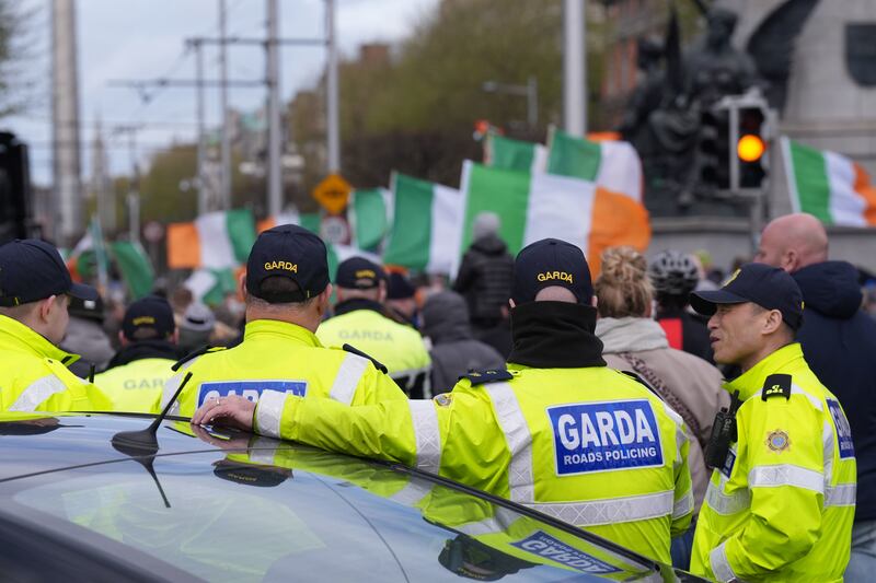 Garda watch protesters on O'Connell Street in Dublin  Photograph:  Niall Carson/PA Wire
