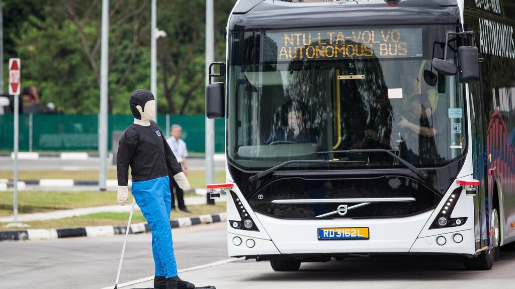 Dummy on a scooter tests the response of a self-driving Volvo bus on trial in Singapore. Photograph: Ore Huiying/Bloomberg
