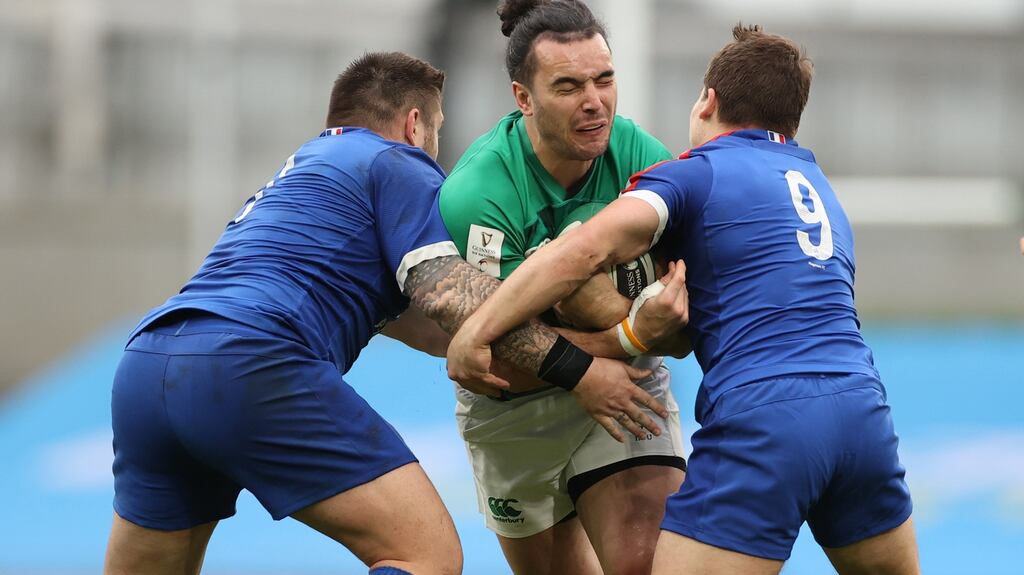 Ireland’s James Lowe is tackled by Cyril Baille and Antoine Dupont of France. Photo: James Crombie/Inpho