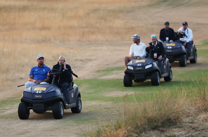 Bryson DeChambeau of the United States is driven by a rules offical on a buggy on day two of The Open. Photograph: Richard Heathcote/Getty