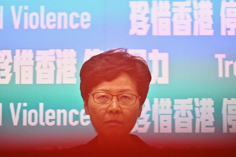 On Friday, Hong Kong’s leader Carrie Lam, partially obscured here by a rope to keep the media at a distance,    invoked a rarely used colonial-era emergency law to ban people from wearing face masks in a bid to put an end to months of violent protests. Photograph: Philip Fong/AFP via Getty