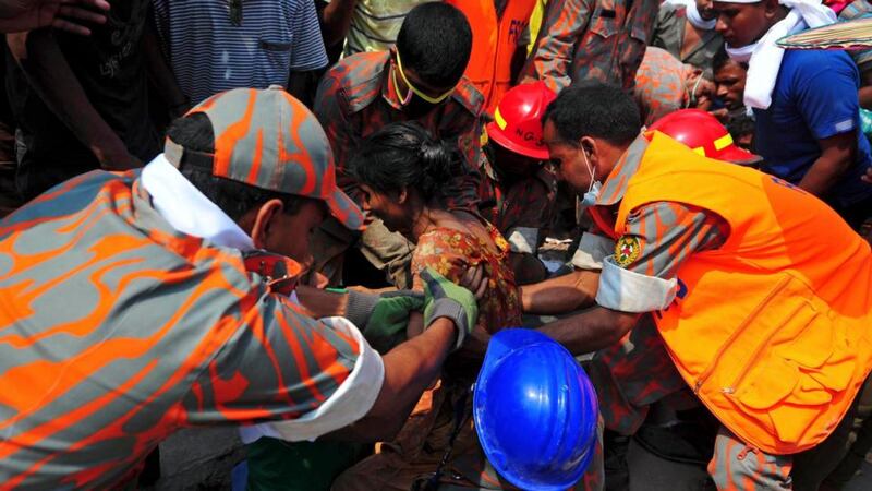 Rescue workers pull a garment worker alive from the rubble of the collapsed Rana Plaza building, in Savar today. Photograph:  REUTERS