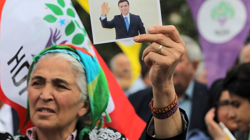A supporter of Turkey’s main pro-Kurdish Peoples’ Democratic Party (HDP) with a picture of its  jailed former leader and presidential candidate Selahattin Demirtas, in Istanbul. Photograph: Huseyin Aldemir