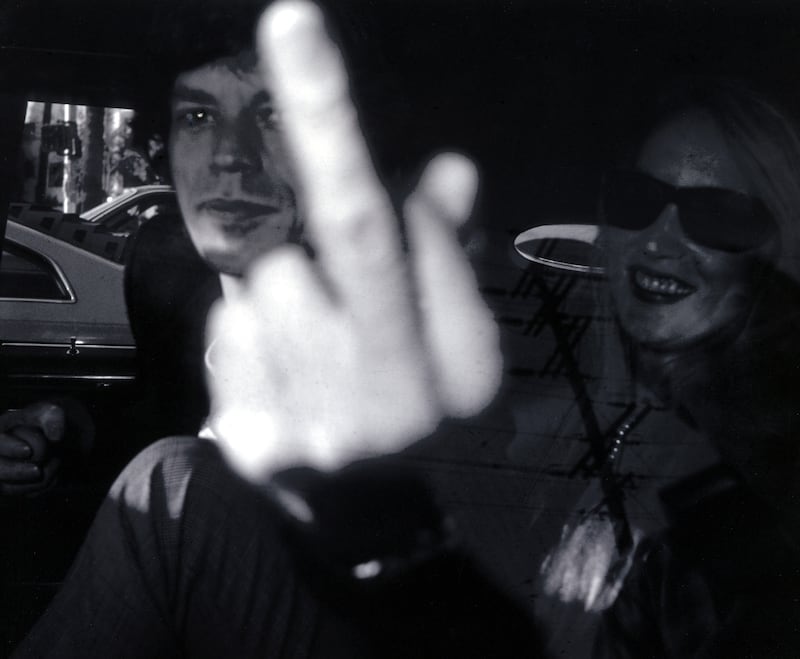 Mick Jagger, travelling with Jerry Hall, reacts to Ron Galella's intrusion in 1983