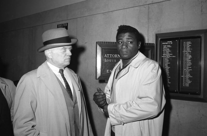 Former heavyweight champion Floyd Patterson (right) with his manager, Cus D'Amato. Photograph: Bettmann Archive/Getty Images