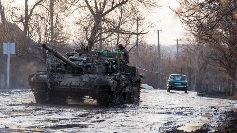 An armoured vehicle pulls a Ukrainian tank in the village of Horlivka, Donetsk region, on February 4, 2015, after it was damaged during combat between the Ukrainian forces and pro-Russian separatists. Photograph: Volodymyr Shuvayev/AFP/Getty Images