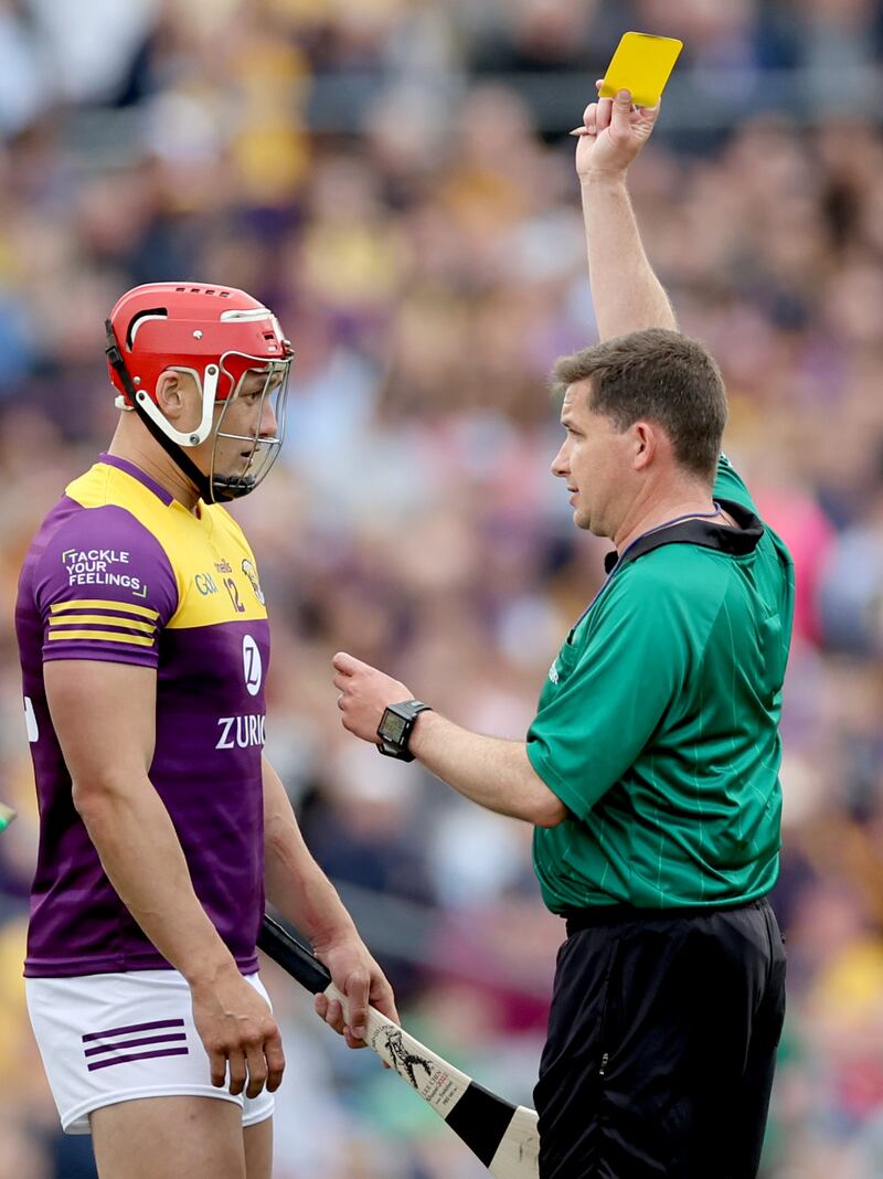 Wexford’s Lee Chin yellow carded by referee Colm Lyons. Photograph: James Crombie/Inpho
