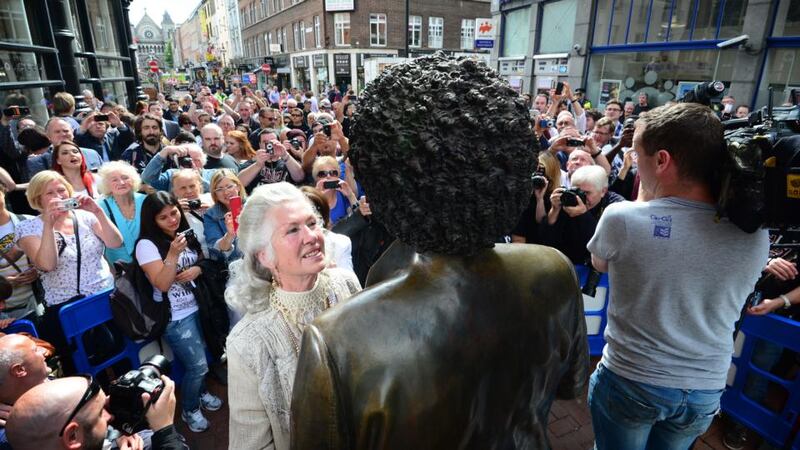 Philomena Lynott looks up at the  statue of her son after it was restored to its place on Dublin’s Harry Street. Photograph: Bryan O’Brien/The Irish Times