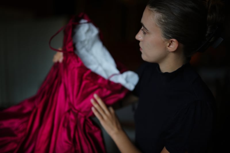 Eleanor Aitken holds the red ball gown by Irish fashion designer Irene Gilbert. Photograph: Bryan O’Brien/The Irish Times